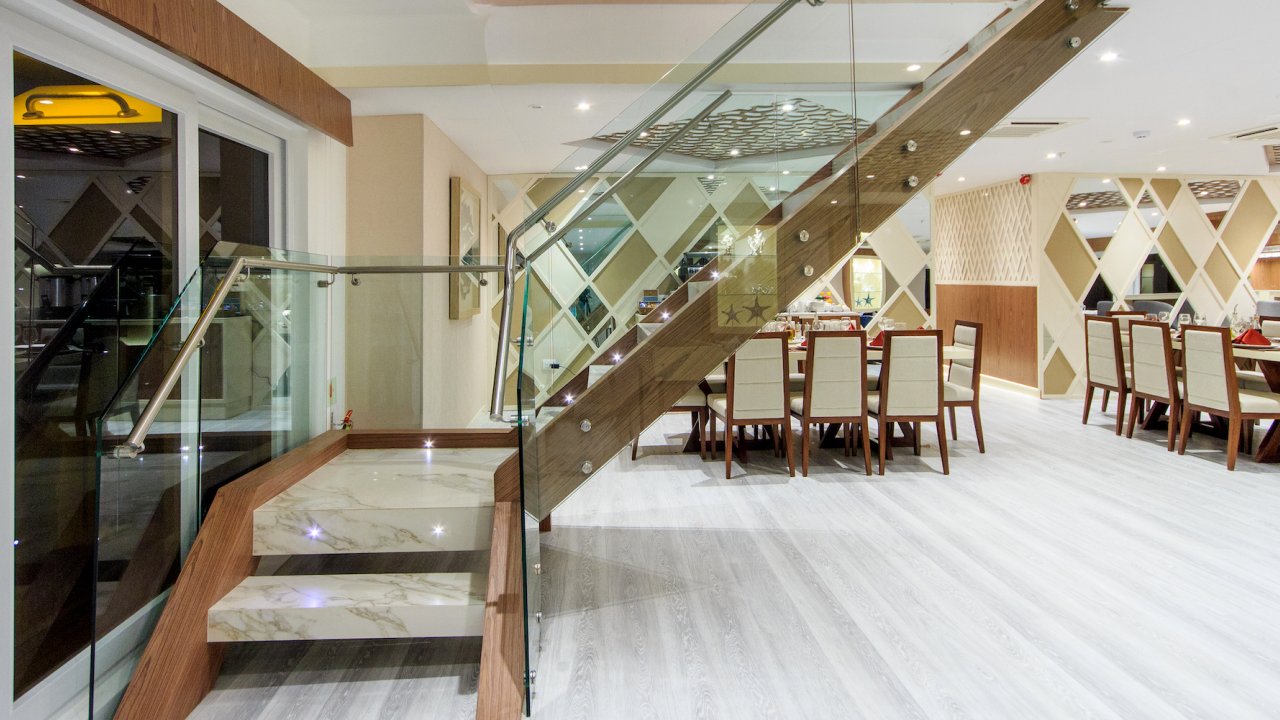 Glass staircase in front of the inside dining room aboard a chartered yacht