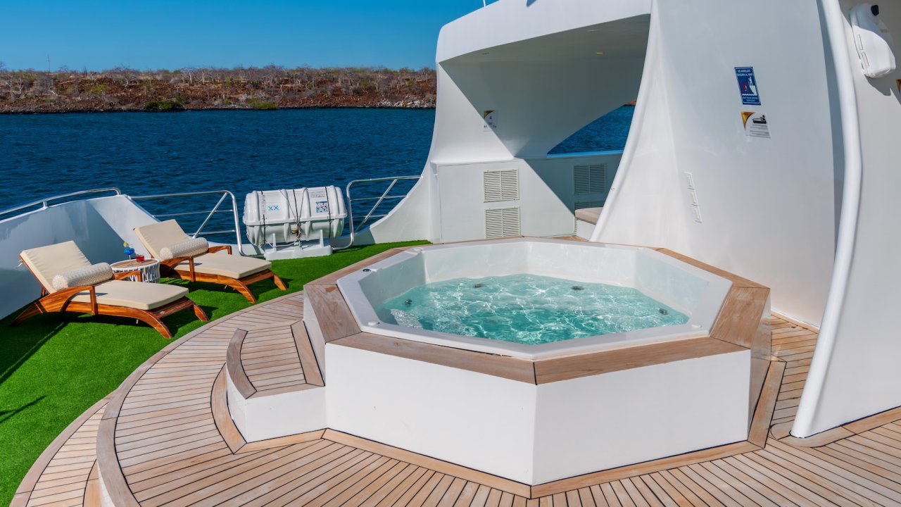 Sun deck with a jacuzzi and chairs set up on the Ocean Spray luxury catamaran ship