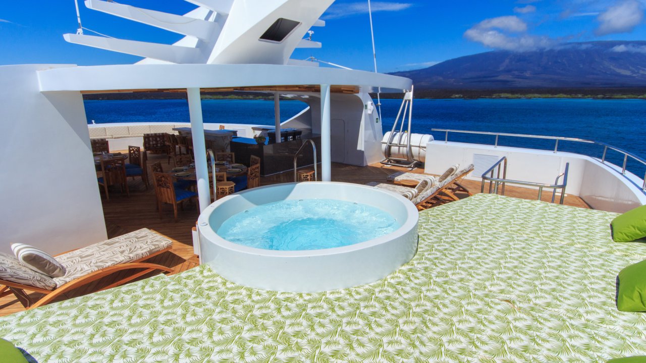Jacuzzi on the sun deck of a small yacht with room to lounge on a sunny day