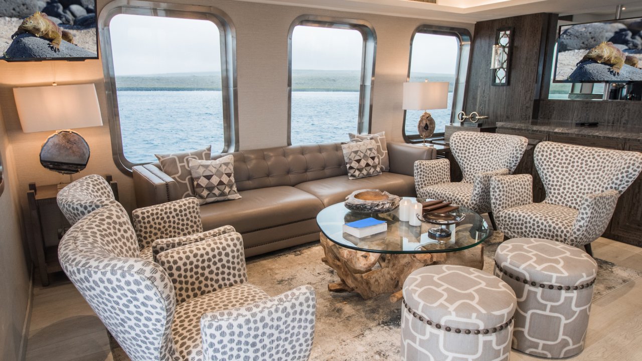 Chairs and a leather couch in a luxury cruise lounge area