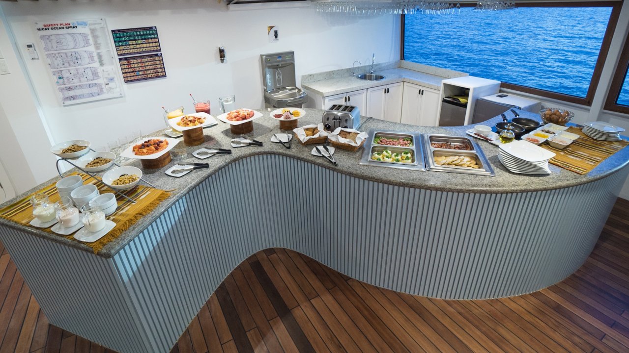 Breakfast buffet set up on an s-curve table on a yacht