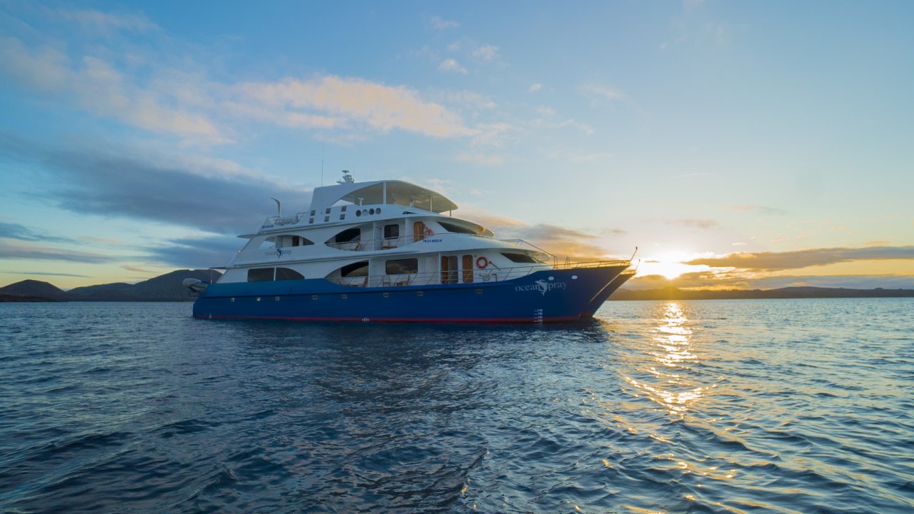 Ocean Spray Catamaran in the water at sunset in the Galapagos Islands