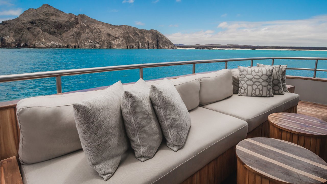 Outside lounge deck on a luxury yacht passing by kicker rock in the Galapagos Islands