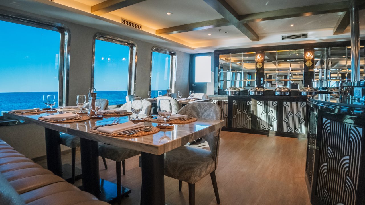Luxury yacht empty indoor dining room at sunset