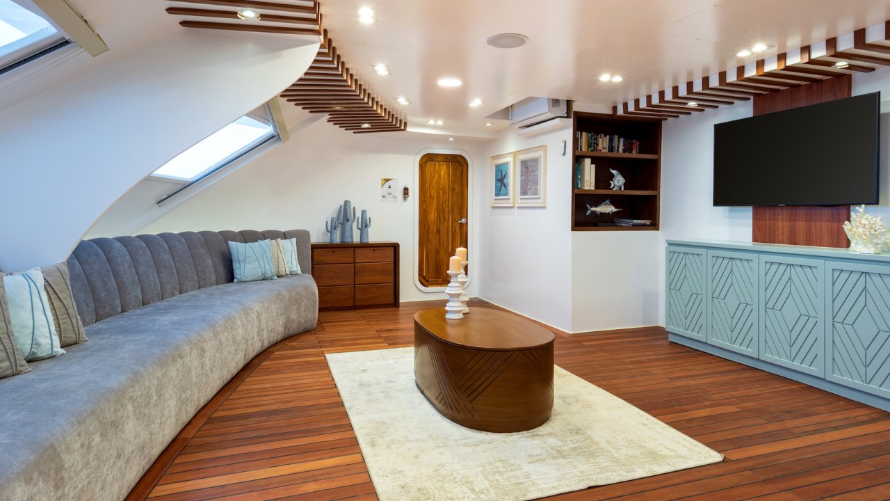 Communal living room area with couches and a TV on a small luxury yacht