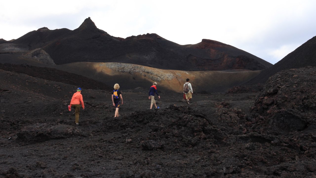 People hiking on a volcano in the Galapagos