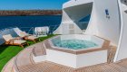 Sun deck with a jacuzzi and chairs set up on the Ocean Spray luxury catamaran ship