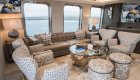 Chairs and a leather couch in a luxury cruise lounge area