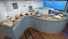 Breakfast buffet set up on an s-curve table on a yacht