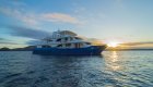 Ocean Spray Catamaran in the water at sunset in the Galapagos Islands