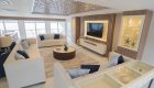 Passanger lounge with couches and a TV aboard a small chartered luxury catamaran ship