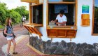 A tourist woman approaching a man at the kiosk of the Charles Darwin Research Center in the Galapagos