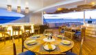 Sky deck on a catamaran cruise ship with tables set up for dining outside