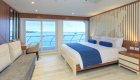 King bed golden stateroom aboard the Elite Catamaran