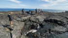 People walking on top of volcanic rock in the Galapagos