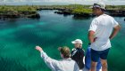 Two people overlooking Galapagos' turquoise archipelago waters